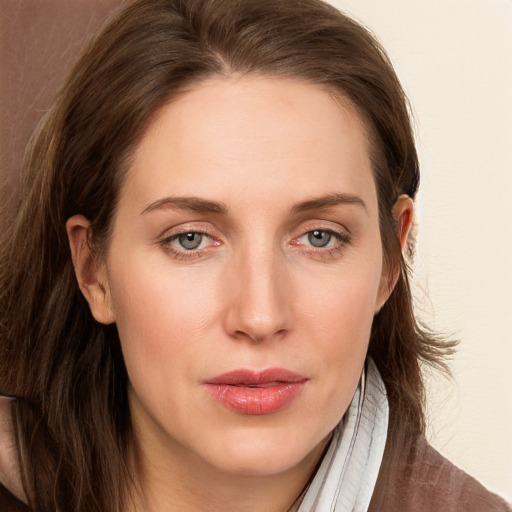 Joyful white young-adult female with long  brown hair and blue eyes