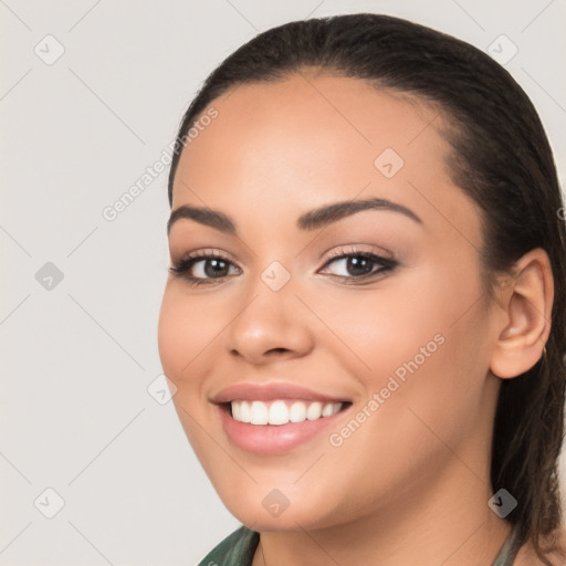 Joyful latino young-adult female with long  brown hair and brown eyes