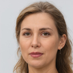 Joyful white adult female with long  brown hair and brown eyes