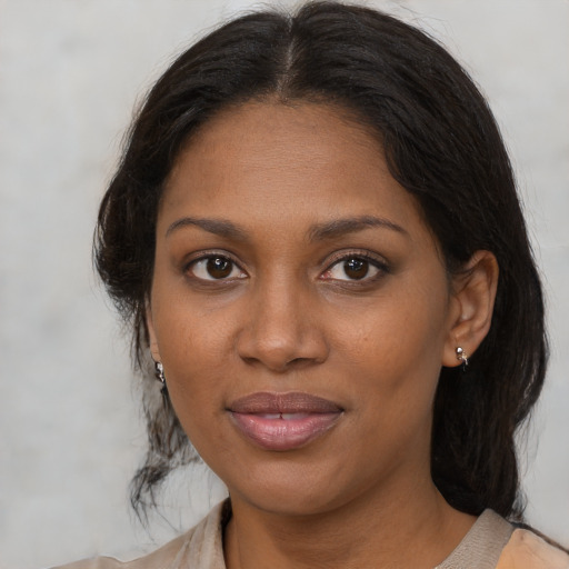 Joyful black young-adult female with medium  brown hair and brown eyes