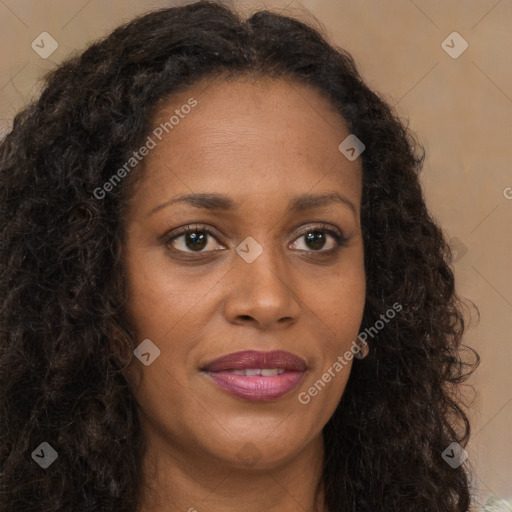 Joyful black young-adult female with long  brown hair and brown eyes