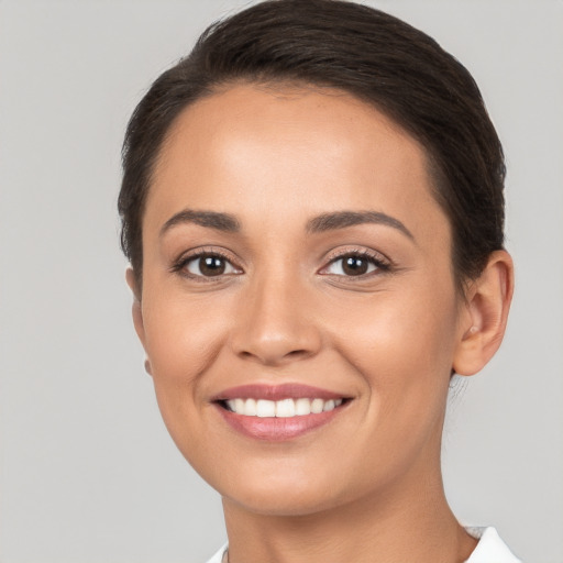 Joyful white young-adult female with short  brown hair and brown eyes