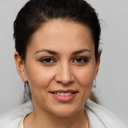 Joyful white adult female with medium  brown hair and brown eyes