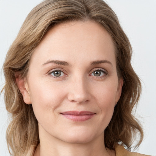 Joyful white young-adult female with medium  brown hair and green eyes