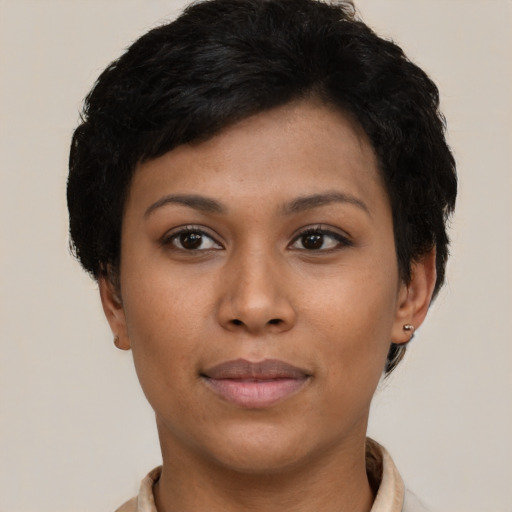 Joyful black young-adult female with short  black hair and brown eyes