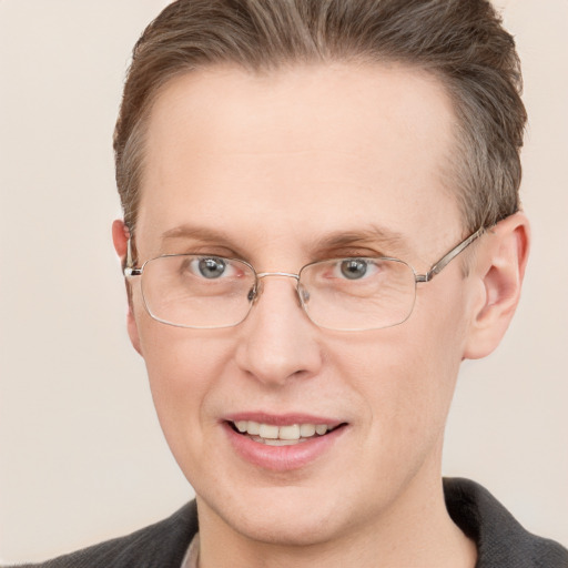 Joyful white adult male with short  brown hair and grey eyes