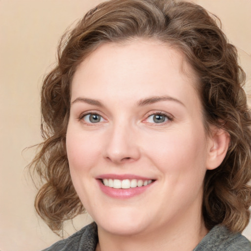 Joyful white young-adult female with medium  brown hair and blue eyes