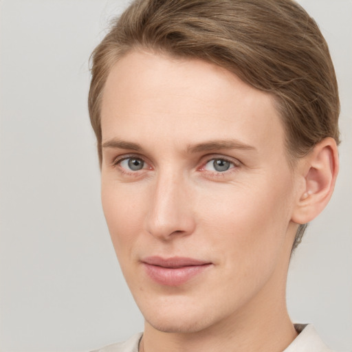 Joyful white young-adult female with short  brown hair and grey eyes