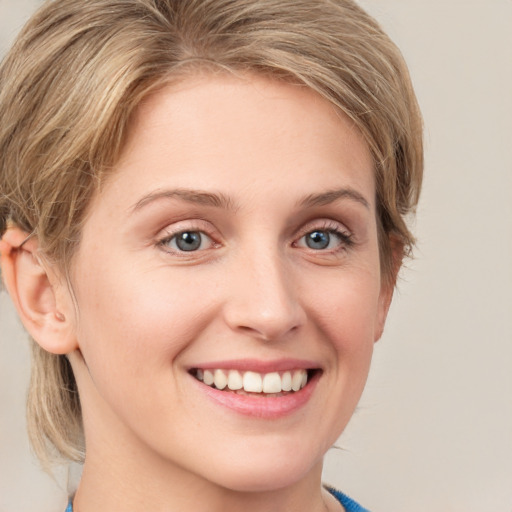 Joyful white young-adult female with medium  brown hair and blue eyes