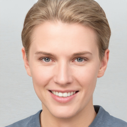 Joyful white young-adult female with short  brown hair and grey eyes