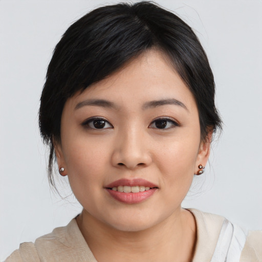 Joyful asian young-adult female with medium  black hair and brown eyes