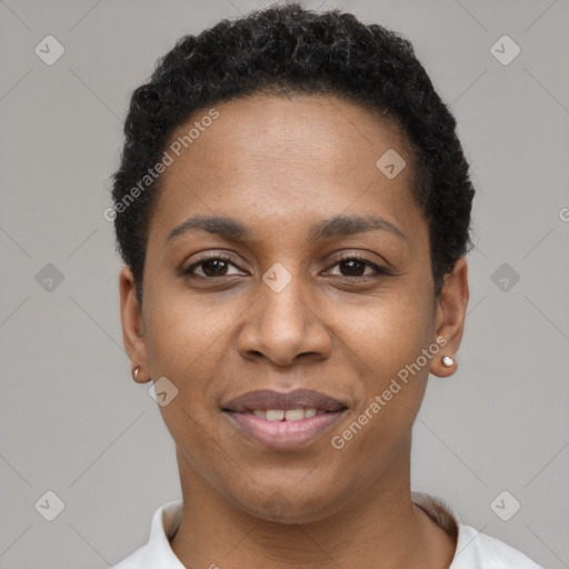 Joyful black young-adult female with short  black hair and brown eyes