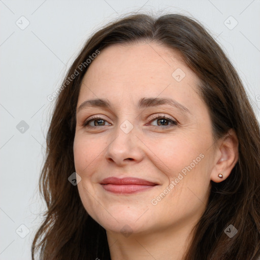 Joyful white adult female with long  brown hair and brown eyes