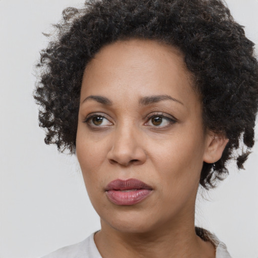 Joyful black adult female with short  black hair and brown eyes