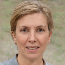 Joyful white adult female with short  brown hair and grey eyes