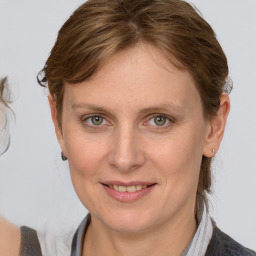 Joyful white young-adult female with medium  brown hair and blue eyes