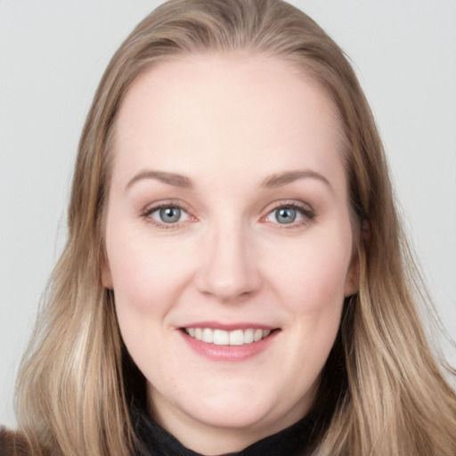 Joyful white young-adult female with long  brown hair and blue eyes