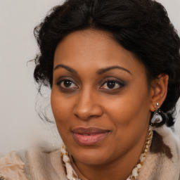 Joyful black adult female with long  brown hair and brown eyes