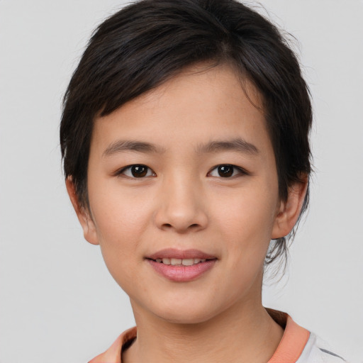 Joyful asian child female with short  brown hair and brown eyes