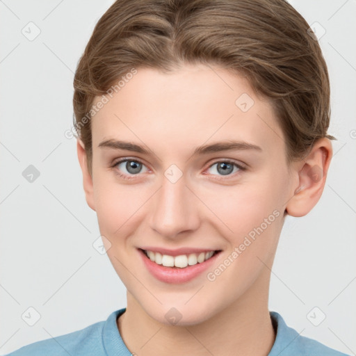 Joyful white young-adult female with short  brown hair and grey eyes