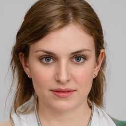 Joyful white young-adult female with medium  brown hair and grey eyes