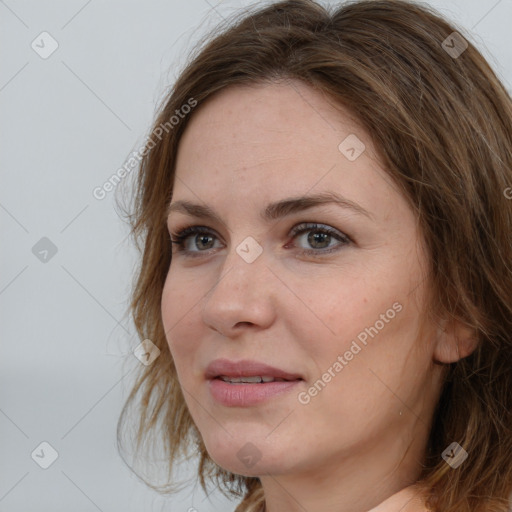 Joyful white adult female with long  brown hair and brown eyes