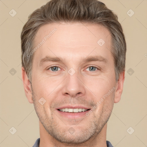 Joyful white adult male with short  brown hair and grey eyes