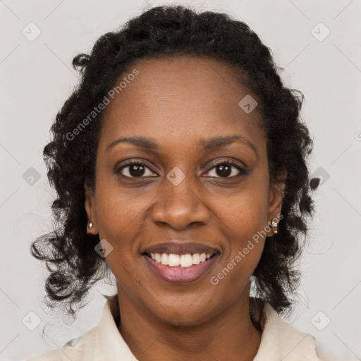 Joyful black young-adult female with long  brown hair and brown eyes