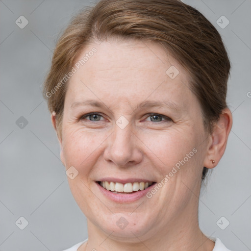 Joyful white adult female with short  brown hair and grey eyes