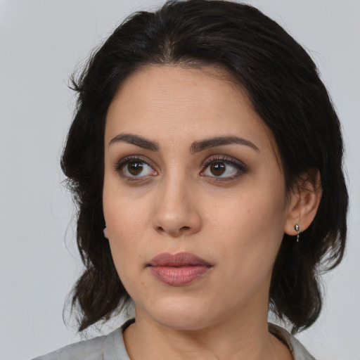 Neutral latino young-adult female with medium  brown hair and brown eyes