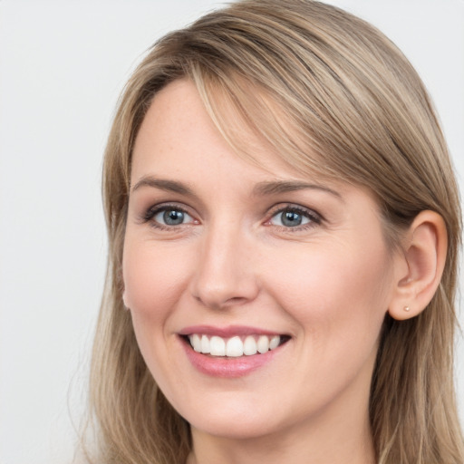 Joyful white young-adult female with long  brown hair and grey eyes