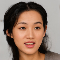 Joyful asian young-adult female with medium  black hair and brown eyes