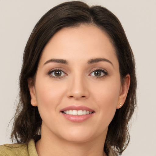 Joyful white young-adult female with medium  brown hair and brown eyes