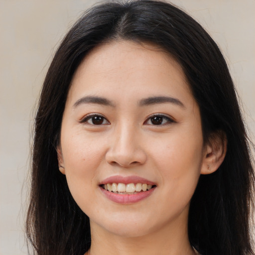 Joyful asian young-adult female with long  brown hair and brown eyes