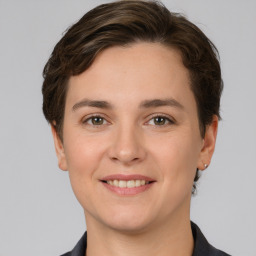 Joyful white young-adult female with short  brown hair and grey eyes