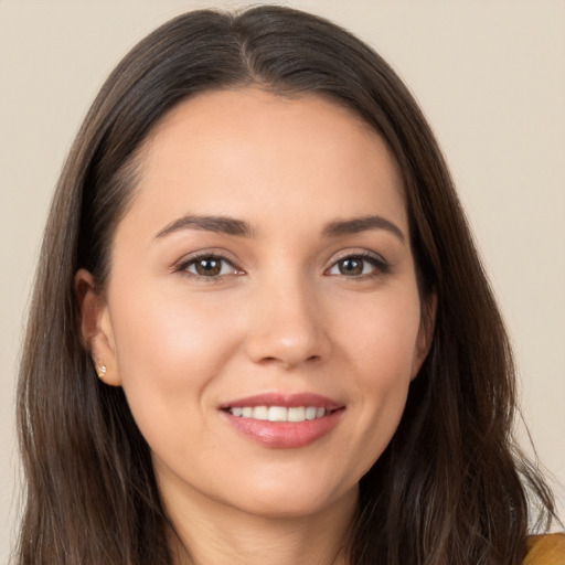 Joyful white young-adult female with long  brown hair and brown eyes