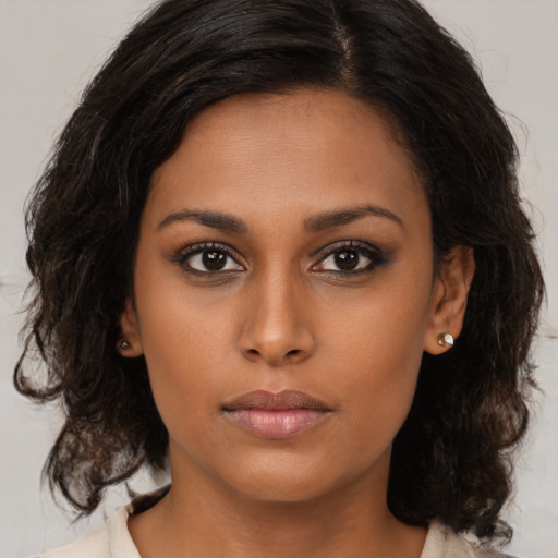 Neutral black young-adult female with medium  brown hair and brown eyes