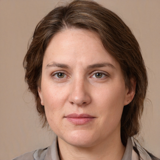 Joyful white adult female with medium  brown hair and grey eyes