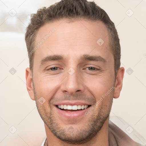 Joyful white young-adult male with short  brown hair and brown eyes