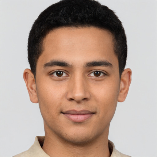 Joyful latino young-adult male with short  brown hair and brown eyes