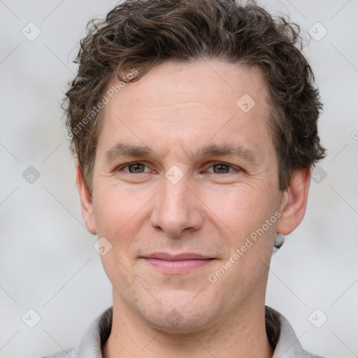 Joyful white adult male with short  brown hair and grey eyes