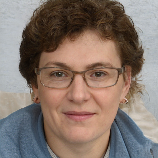 Joyful white adult female with medium  brown hair and blue eyes