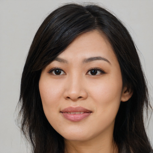 Joyful asian young-adult female with long  brown hair and brown eyes