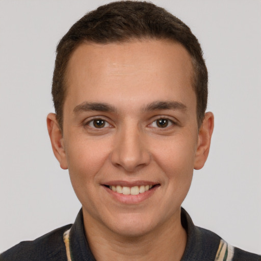 Joyful white young-adult male with short  brown hair and brown eyes