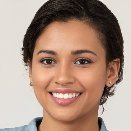 Joyful white young-adult female with medium  brown hair and brown eyes