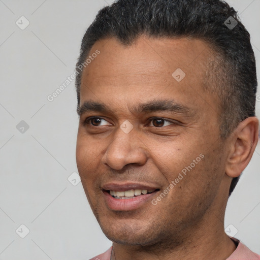 Joyful latino adult male with short  brown hair and brown eyes