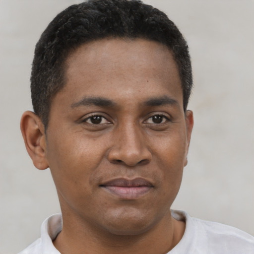Joyful latino young-adult male with short  brown hair and brown eyes