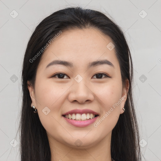 Joyful asian young-adult female with long  brown hair and brown eyes