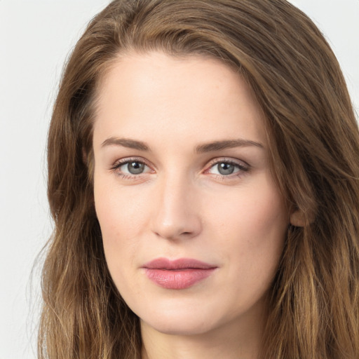 Joyful white young-adult female with long  brown hair and green eyes