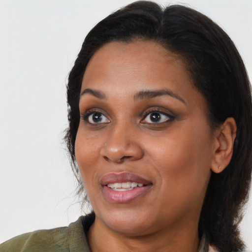 Joyful black young-adult female with medium  black hair and brown eyes
